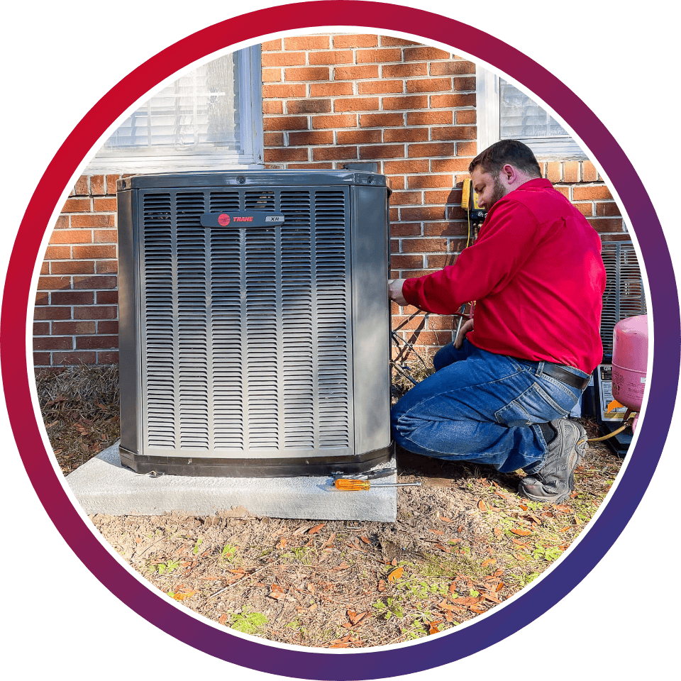 HVAC technician performing maintenance on a heat pump in Brunswick County.