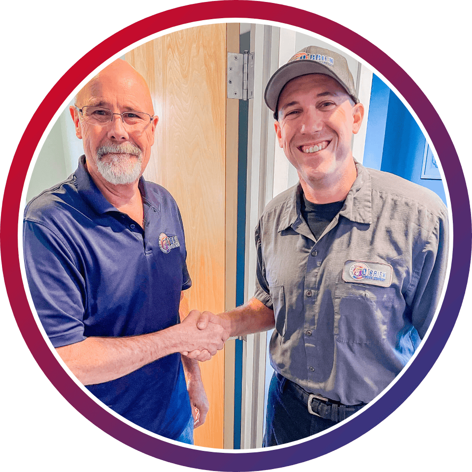 O'Brien Service Company owner shaking hands with employee at Wilmington, NC, office.