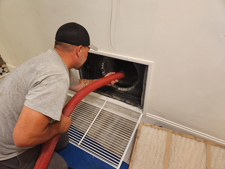 An O'Brien Service Company technician is performing duct cleaning.