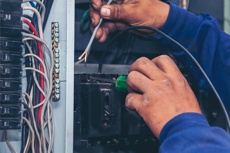 A service tech working on a HVAC unit.