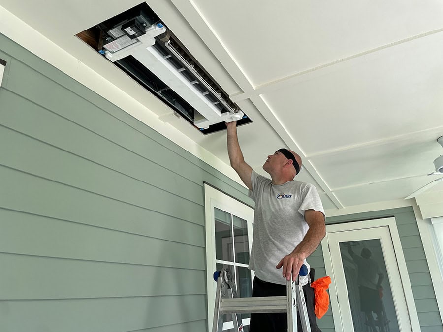 An O'Brien Service Company installer installing a ductless mini split system.