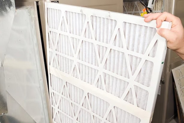 Changing out of a furnace filter.